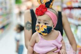 baby girl wearing mask in grocery store